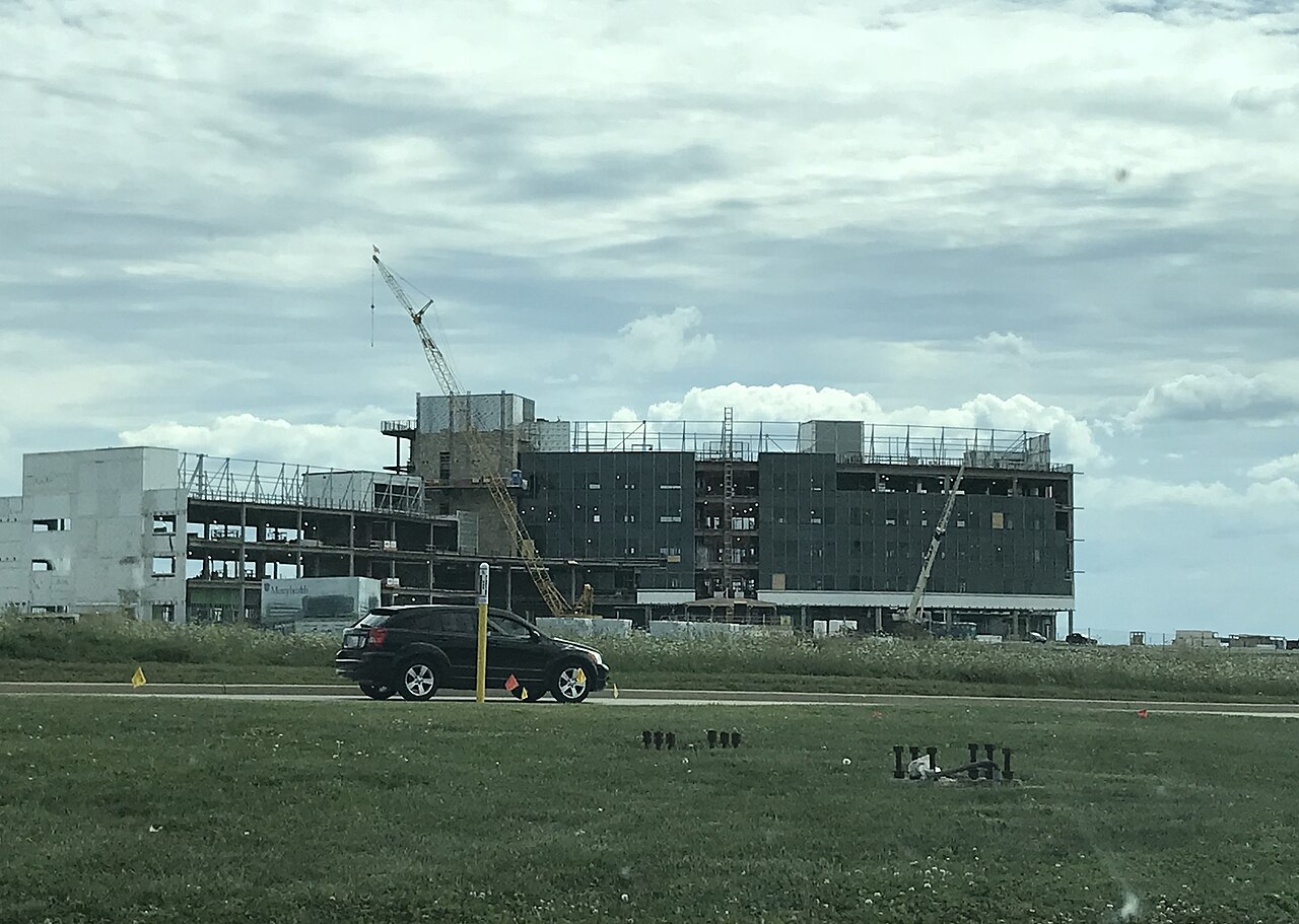 Multi-story commercial building under construction with tower crane
